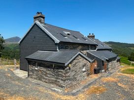 A house with a stone exterior and slate roof at Ty Llewelyn in Capel Curig near Betws-Y-Coed