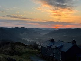 A house with sunset view in the background at Ty Llewelyn Capel Curig near Betws-Y-Coed