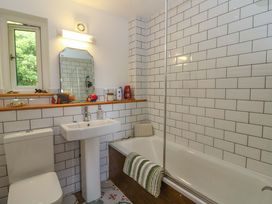 A bathroom with a sink and bathtub at Delfryn in Llandeilo