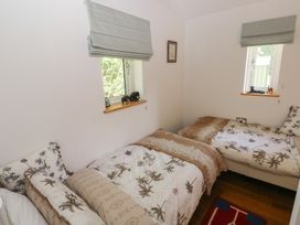 A bedroom with two beds and windows at Delfryn Llandeilo near Llandeilo