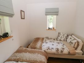 A bedroom with two beds and animal figurines at Delfryn Llandeilo near Llandeilo
