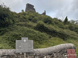 Ruins of a castle with a sign at Castell Dryslywn Castle near Llandeilo