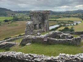 A castle ruin with grass and river view at Delfryn Llandeilo near Llandeilo