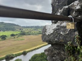 A close-up of a lock on a railing with a scenic view at Delfryn Llandeilo near Llandeilo