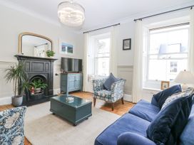 A living room with a sofa and armchair in 11A High Street, Jedburgh