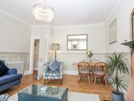 A living room with a sofa and dining set at 11A High Street in Jedburgh