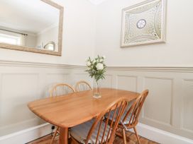 A dining room with a table and chairs at 11A High Street Jedburgh