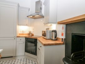 A kitchen with appliances and storage at 11A High Street Jedburgh