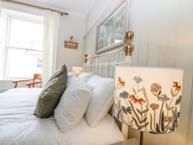 A bedroom with a bed and a lamp at 11A High Street in Jedburgh