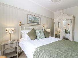 A bedroom with a bed and bedside tables at 11A High Street in Jedburgh