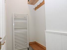 A utility room with a towel radiator and hooks at 11A High Street in Jedburgh