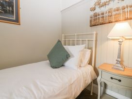 A bedroom with a bed and lamp at 11A High Street, Jedburgh