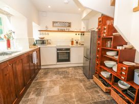 A kitchen with appliances and dishes at The Stables in St Just