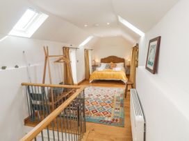 A bedroom with a bed and rug at The Stables in St Just
