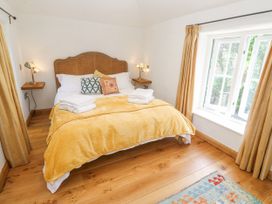 A bedroom with a bed and a window at The Stables in St Just