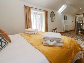 A bedroom with a bed and blankets at The Stables in St Just