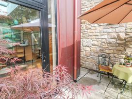 An outdoor seating area with a table and chairs at The Stables in St Just
