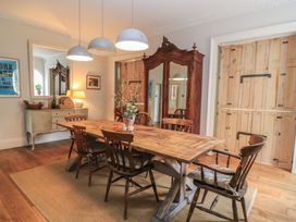 A dining room with a wooden table and chairs at Cotswold House Moreton-In-Marsh