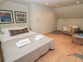 A bedroom with a bed and artwork at Cotswold House in Moreton-In-Marsh