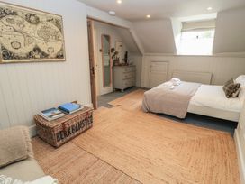 A bedroom with a bed and storage basket at Cotswold House in Moreton-In-Marsh