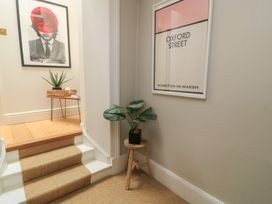 A hallway with a staircase and plant at Cotswold House Moreton-In-Marsh