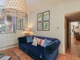 A living room with a sofa and wall art at Cotswold House in Moreton-In-Marsh