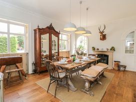 A dining room with a table set for meals at Cotswold House, Moreton-In-Marsh