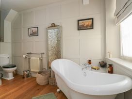 A bathroom with a bathtub and toilet at Cotswold House Moreton-In-Marsh