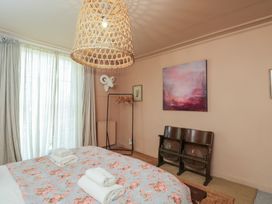 A bedroom with a bed and artwork on the wall at Cotswold House in Moreton-In-Marsh