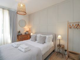 A bedroom with a bed and dresser at Cotswold House Moreton-In-Marsh