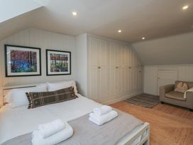 A bedroom with a bed and pictures on the wall at Cotswold House in Moreton-In-Marsh