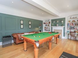 A snug with a snooker table and a sofa at Cotswold House in Moreton-In-Marsh