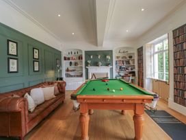 A snug with a pool table and a sofa at Cotswold House in Moreton-In-Marsh