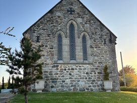 A stone building with a window and plants at St Edmunds Church in Fraisthorpe