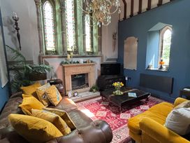 A living room with a fireplace and sofa at St Edmunds Church in Fraisthorpe