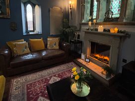 A living room with a sofa and fireplace at St Edmunds Church in Fraisthorpe