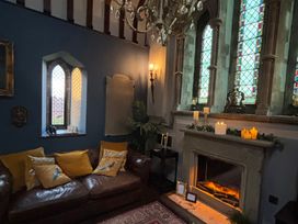 A living room with a couch and stained glass windows at St Edmunds Church in Fraisthorpe