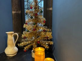 A Christmas tree and candles near a window at St Edmunds Church in Fraisthorpe