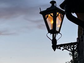 A lantern with light mounted outdoors at St Edmunds Church in Fraisthorpe