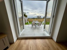 A view of a patio with an outdoor table and chairs at Golygfa in Llangristiolus near Llangefni