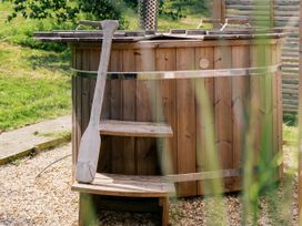 A hot tub with wooden steps in an outdoor area at Lillie's Shepherds Hut at Shepherds Lodge Retreat and Wellness Bottesford near Redmile and Vale of Belvoir