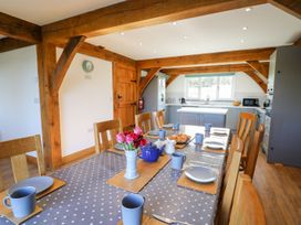 A kitchen with a dining table set for tea including cups plates and a teapot at Yr Adfa Llangeitho near Tregaron