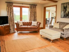 A living room with two sofas a television and an ottoman at White House in Montgomery