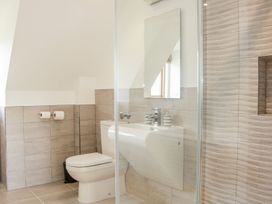 A bathroom with a toilet sink mirror and tiled walls at White House in Montgomery