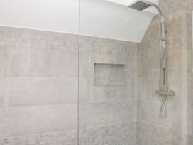 A shower area with built in niche and wall mounted shower fixture at White House in Montgomery