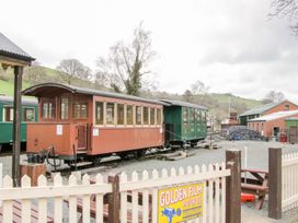 A vintage train carriage at a railway yard with coal piles and brick buildings at White House in Montgomery