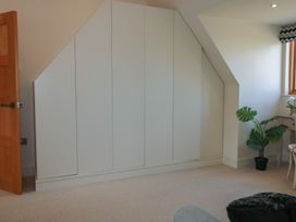 A bedroom with a wardrobe and a plant at White House in Montgomery