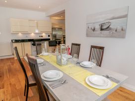 A dining table set with plates glasses and cutlery in a kitchen dining area at Walworth Castle Lodge in Walworth near Darlington