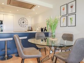 A dining area with a glass table and chairs at Apartment 8 