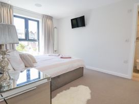 A bedroom with a bed and television at Apartment 8